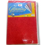 Child cutting glitter foam sheet with scissors